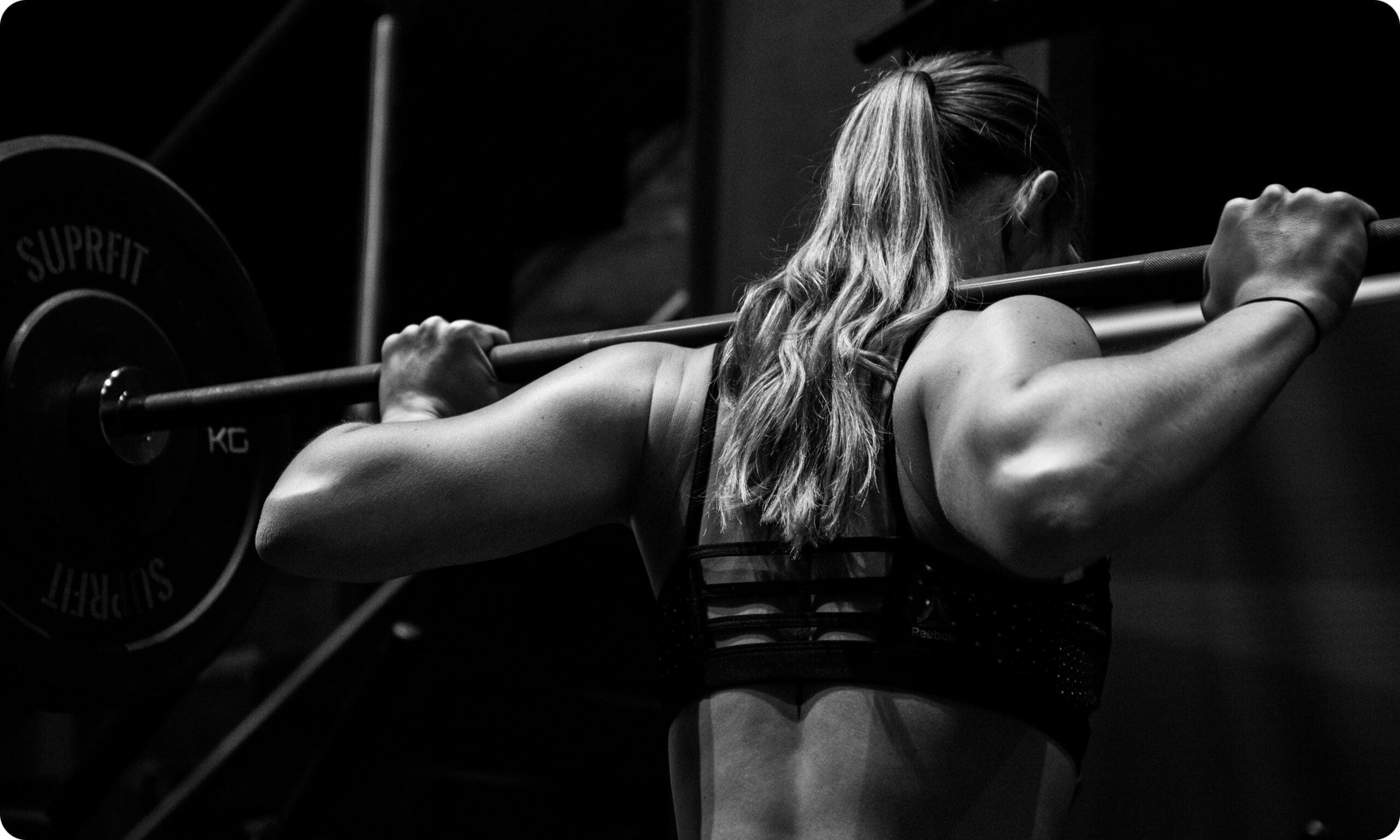 Person lifting barbell during workout