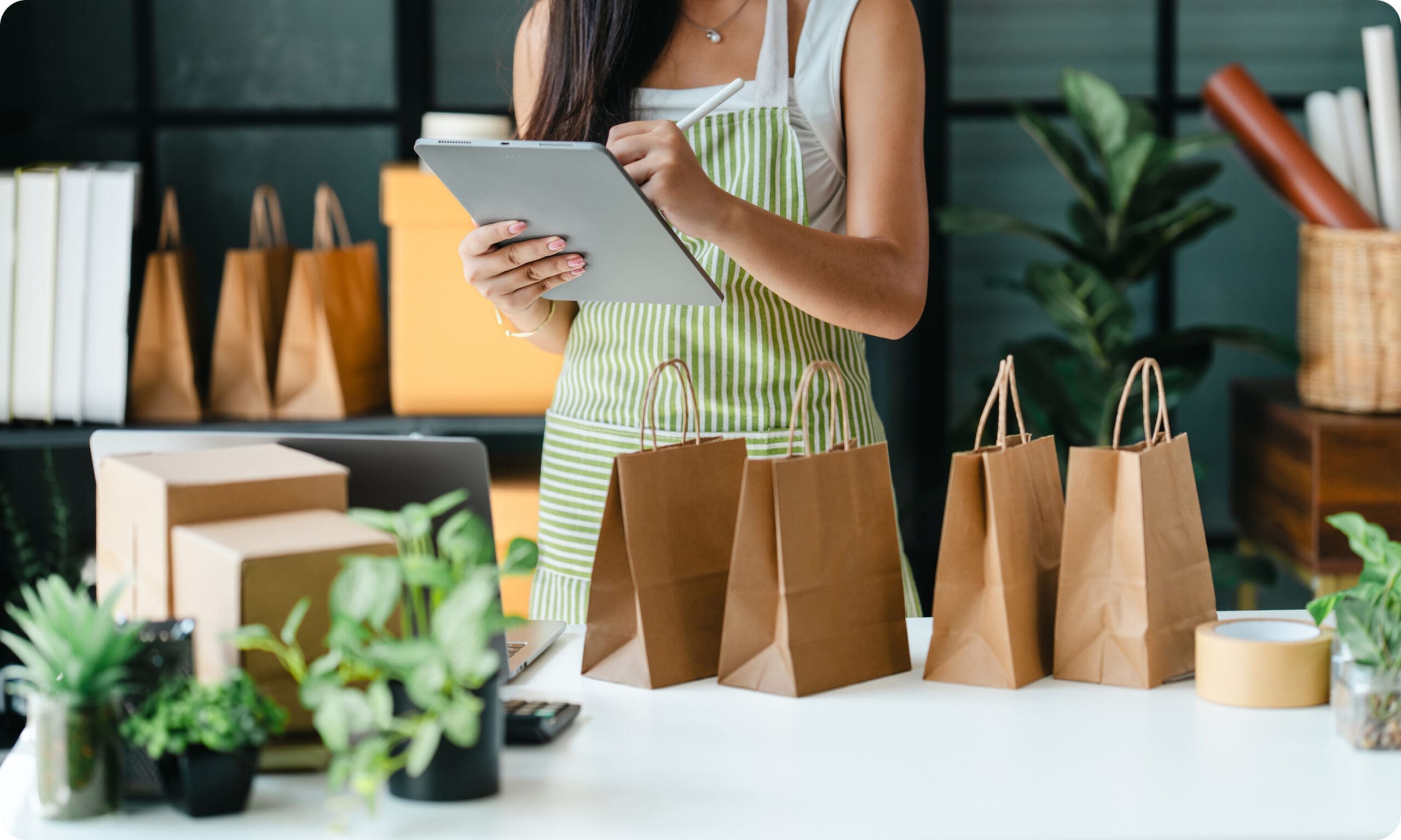 Small business owner preparing customer orders using a tablet