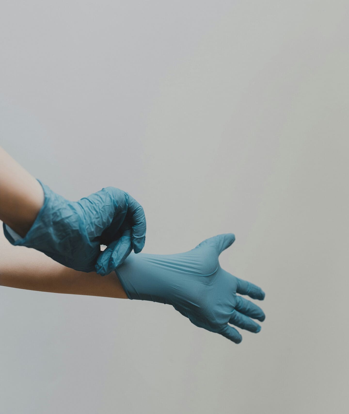 Healthcare worker putting on medical gloves
