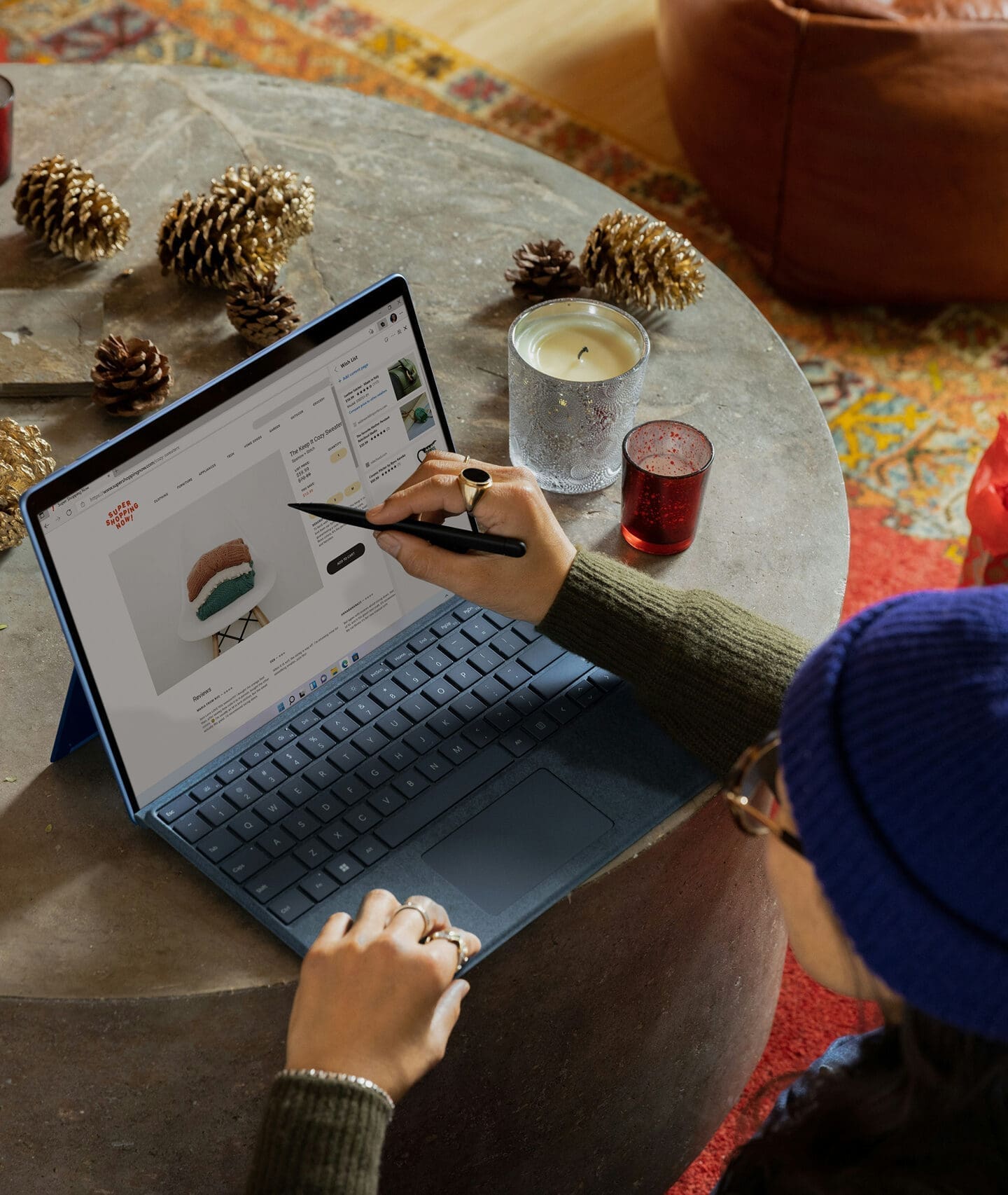 Person using stylus on laptop while viewing product page