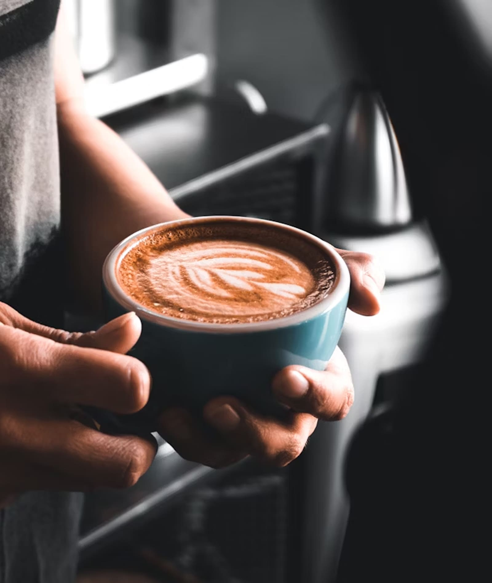 Barista holding cup of coffee