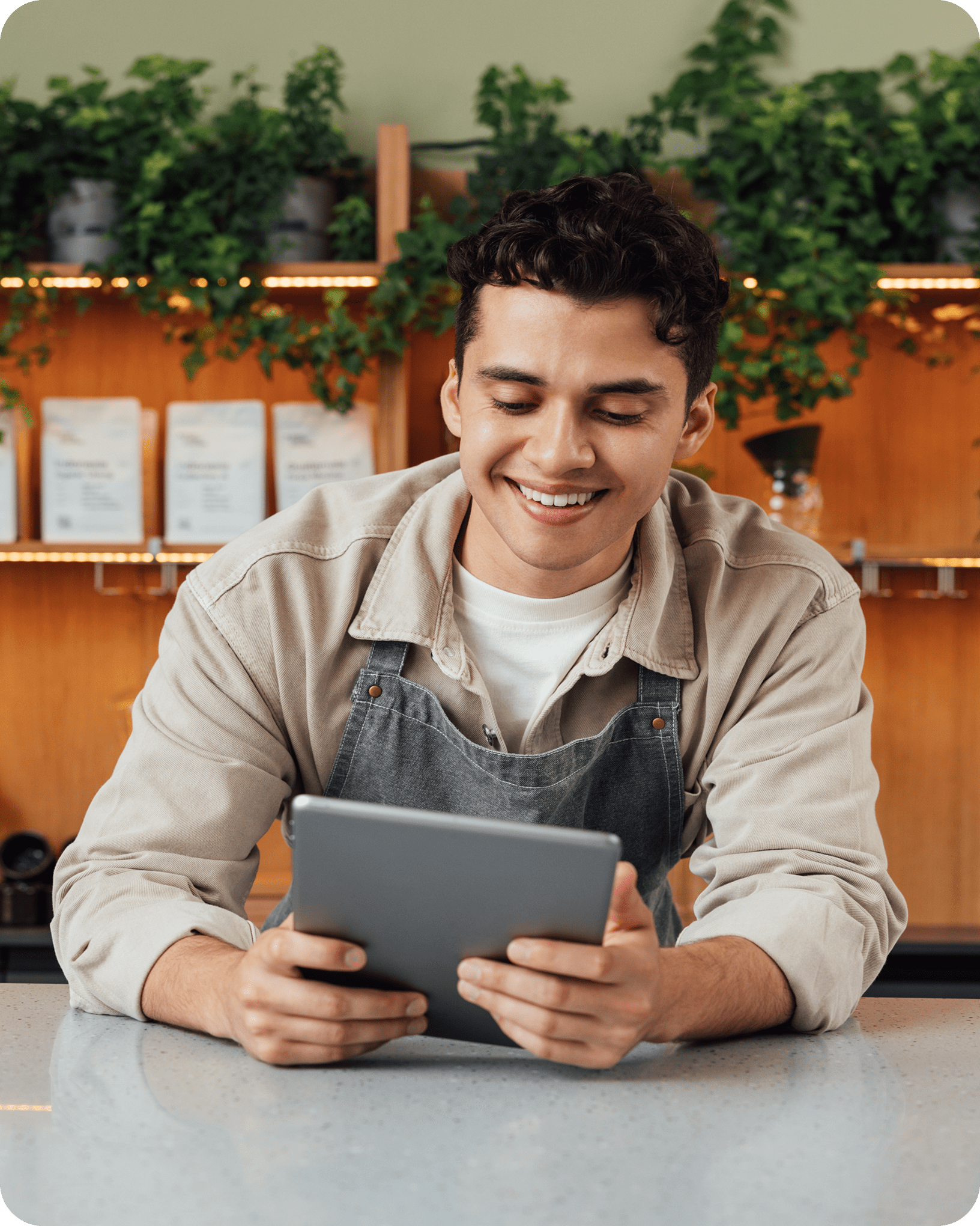 Retail merchant using tablet behind store counter