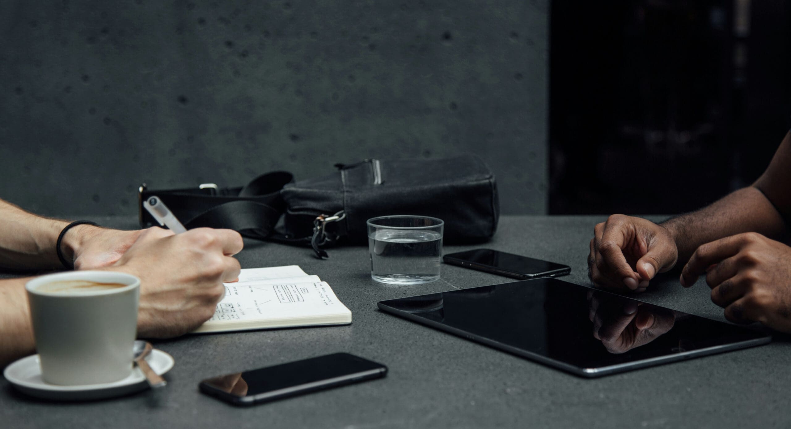 Meeting with tablet and notes on table