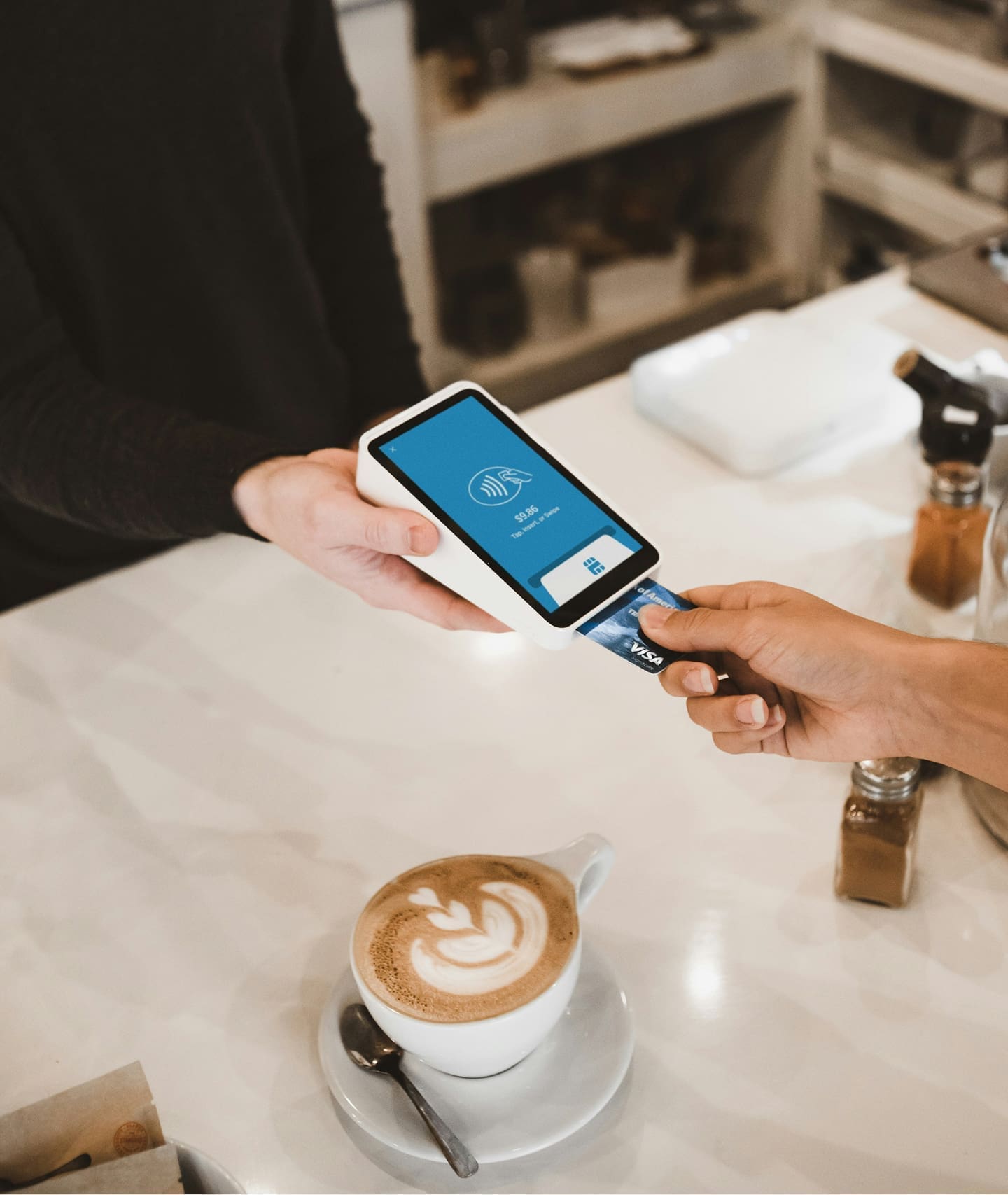Customer paying at counter using card reader