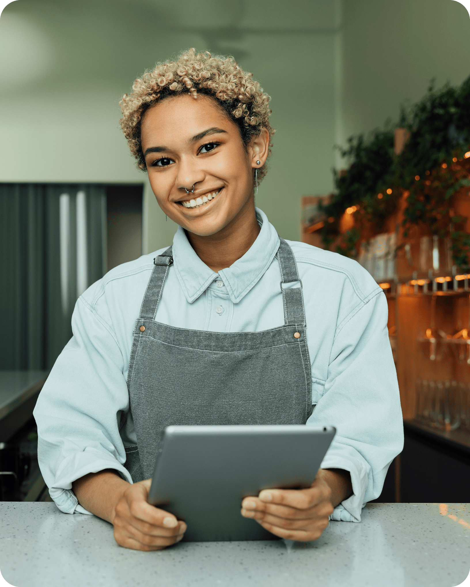 Merchant using tablet behind store counter