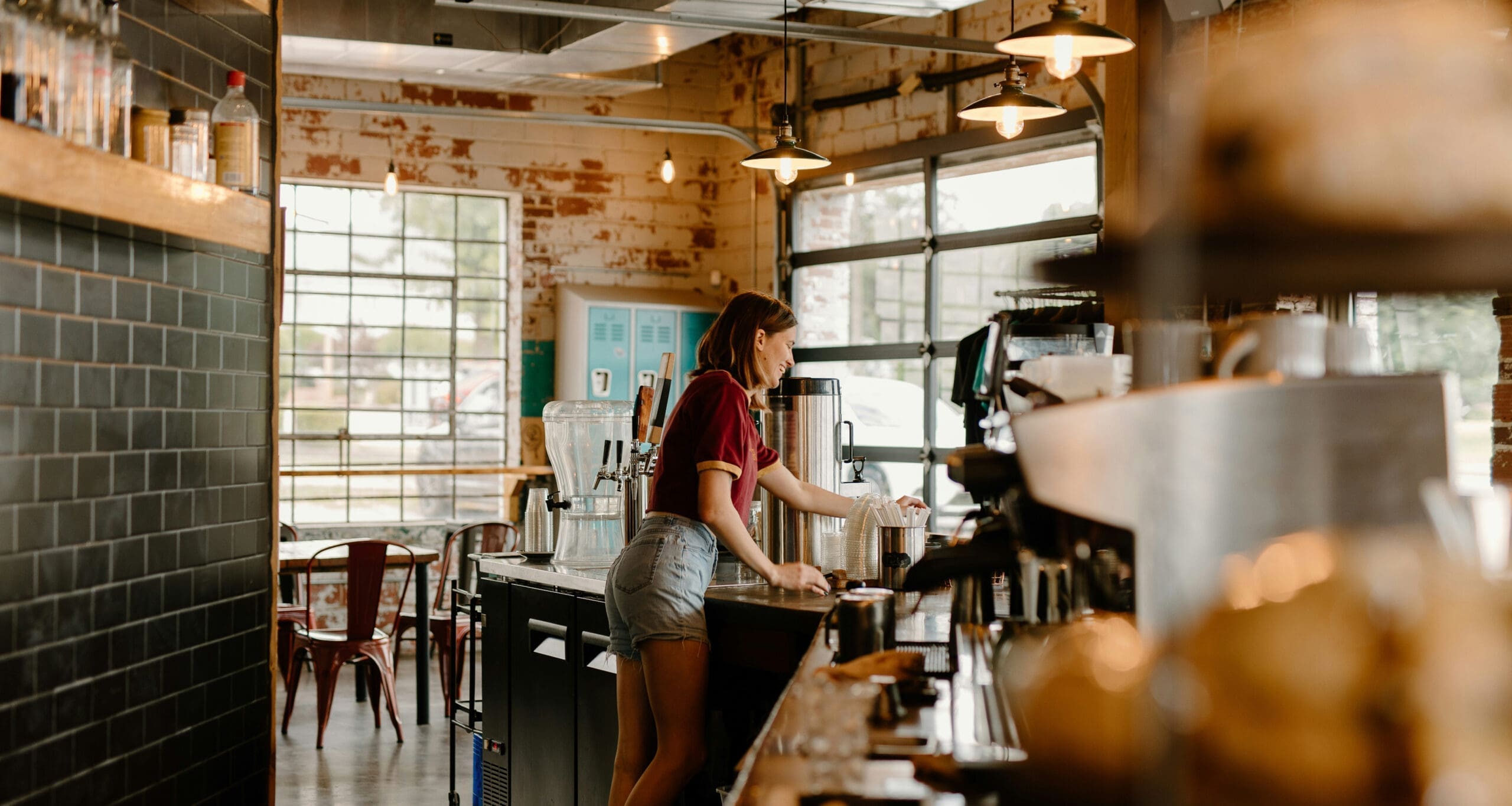 Barista behind cafe counter