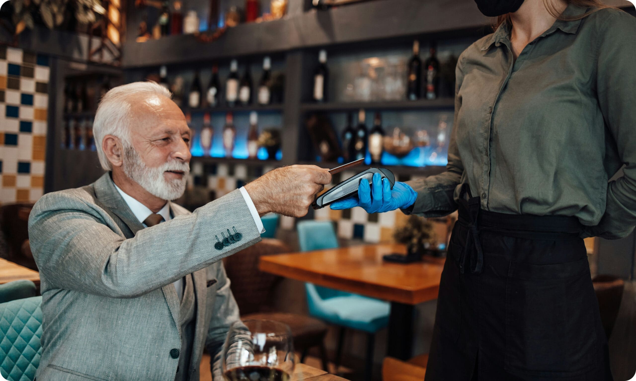 Customer tapping contactless card on payment reader