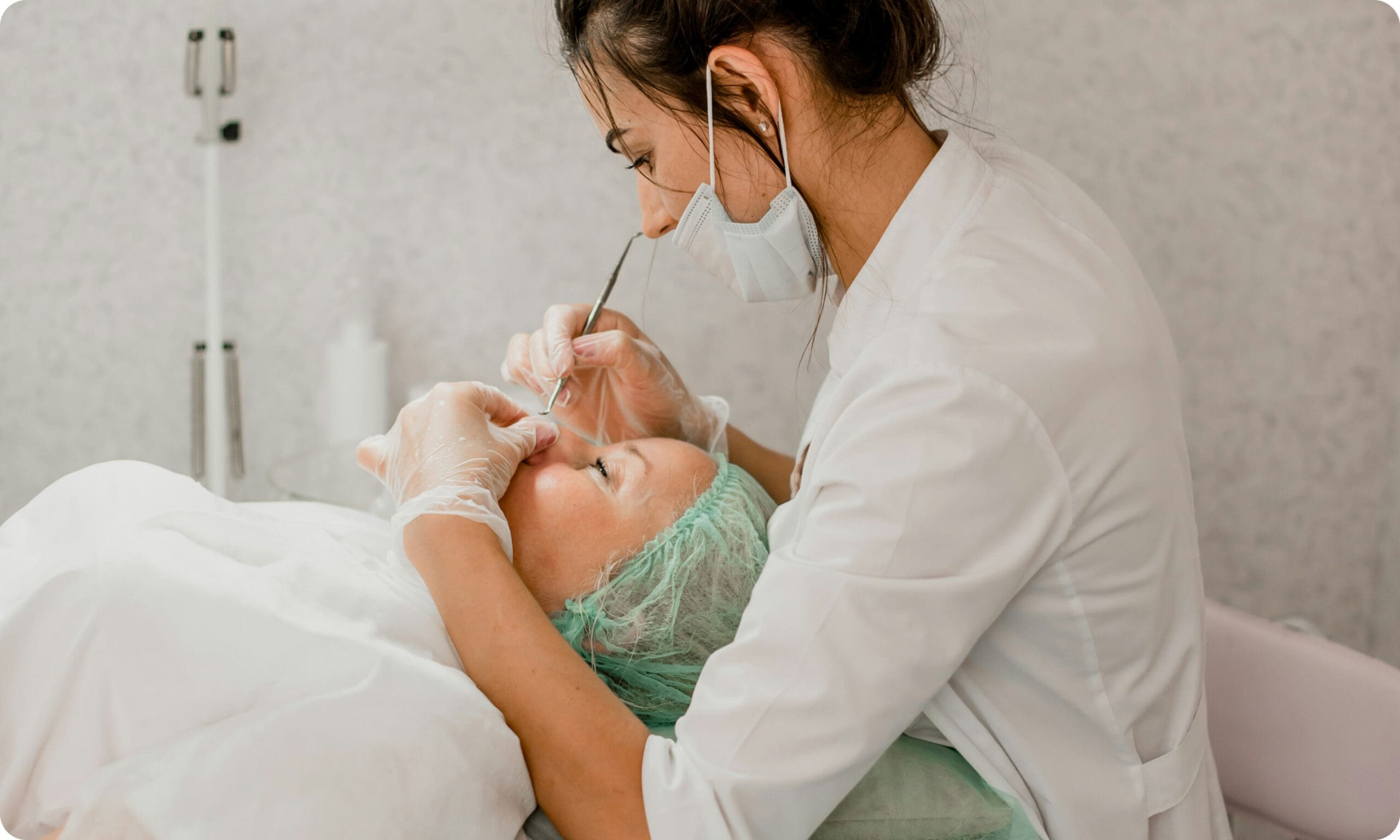 Esthetician performing cosmetic treatment on client