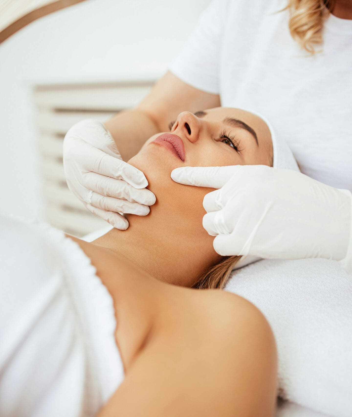 Esthetician performing facial treatment