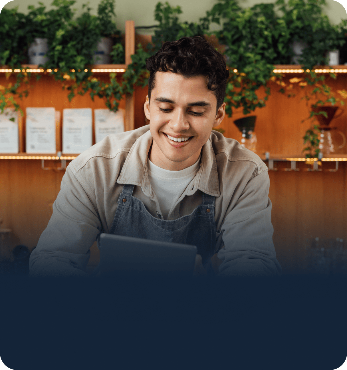 Retail merchant using tablet behind store counter