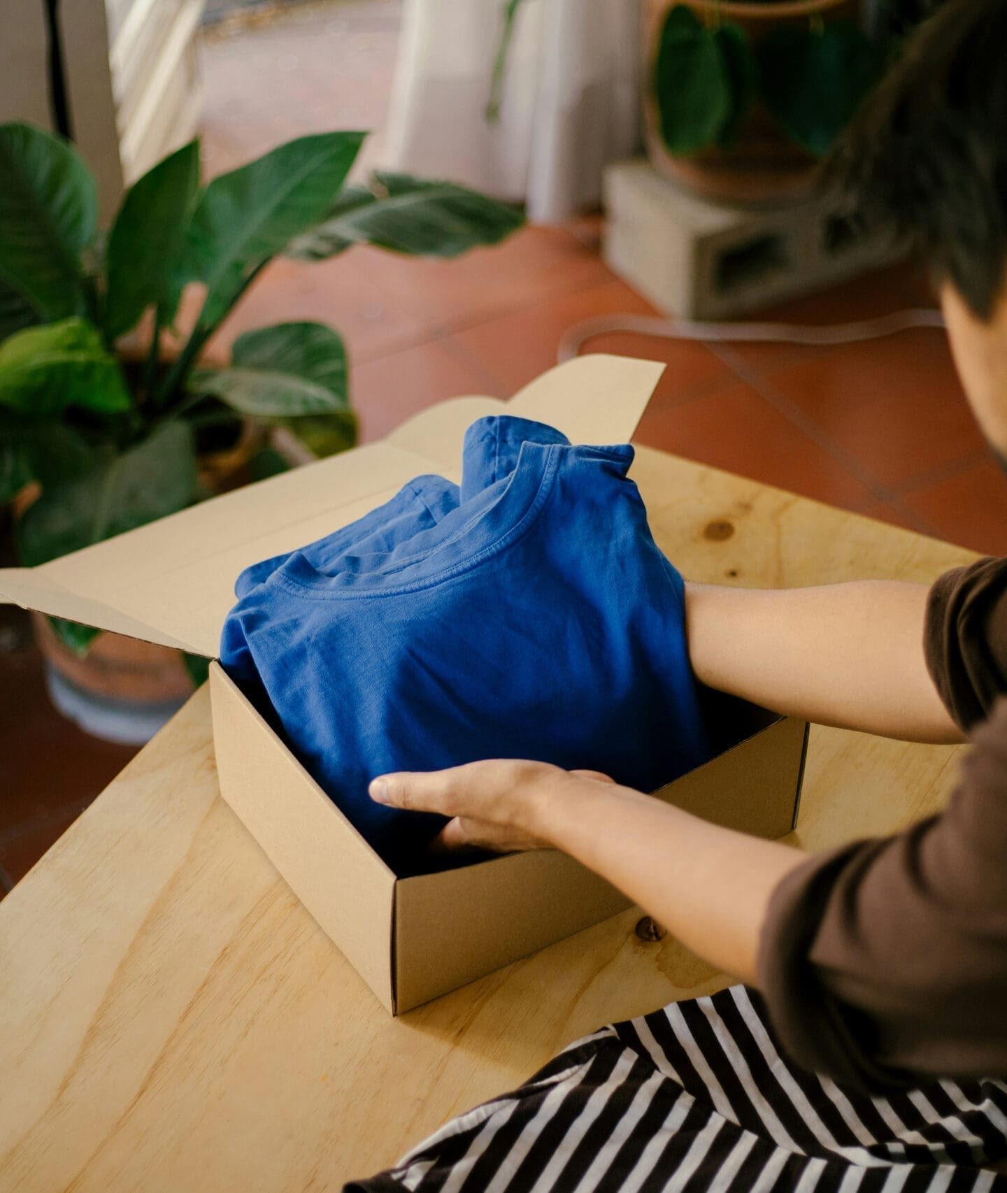 Packing clothes into shipping box