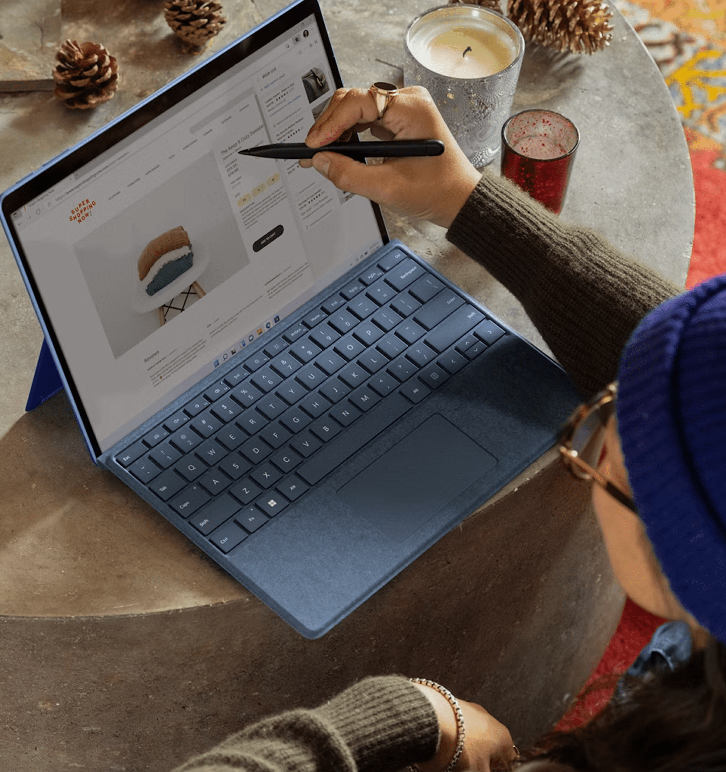 Person working on laptop with pen