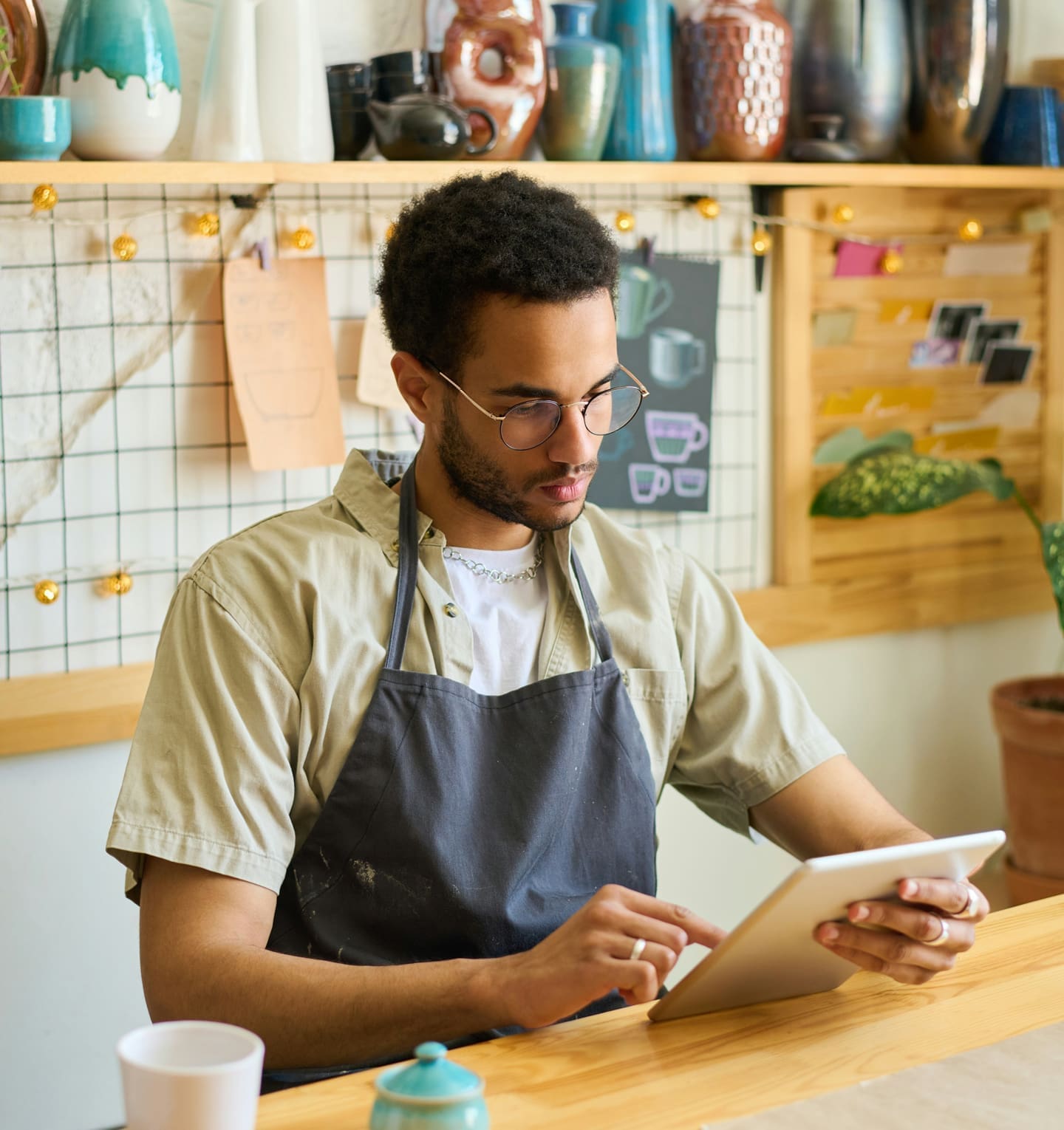 Business owner writing notes at workbench