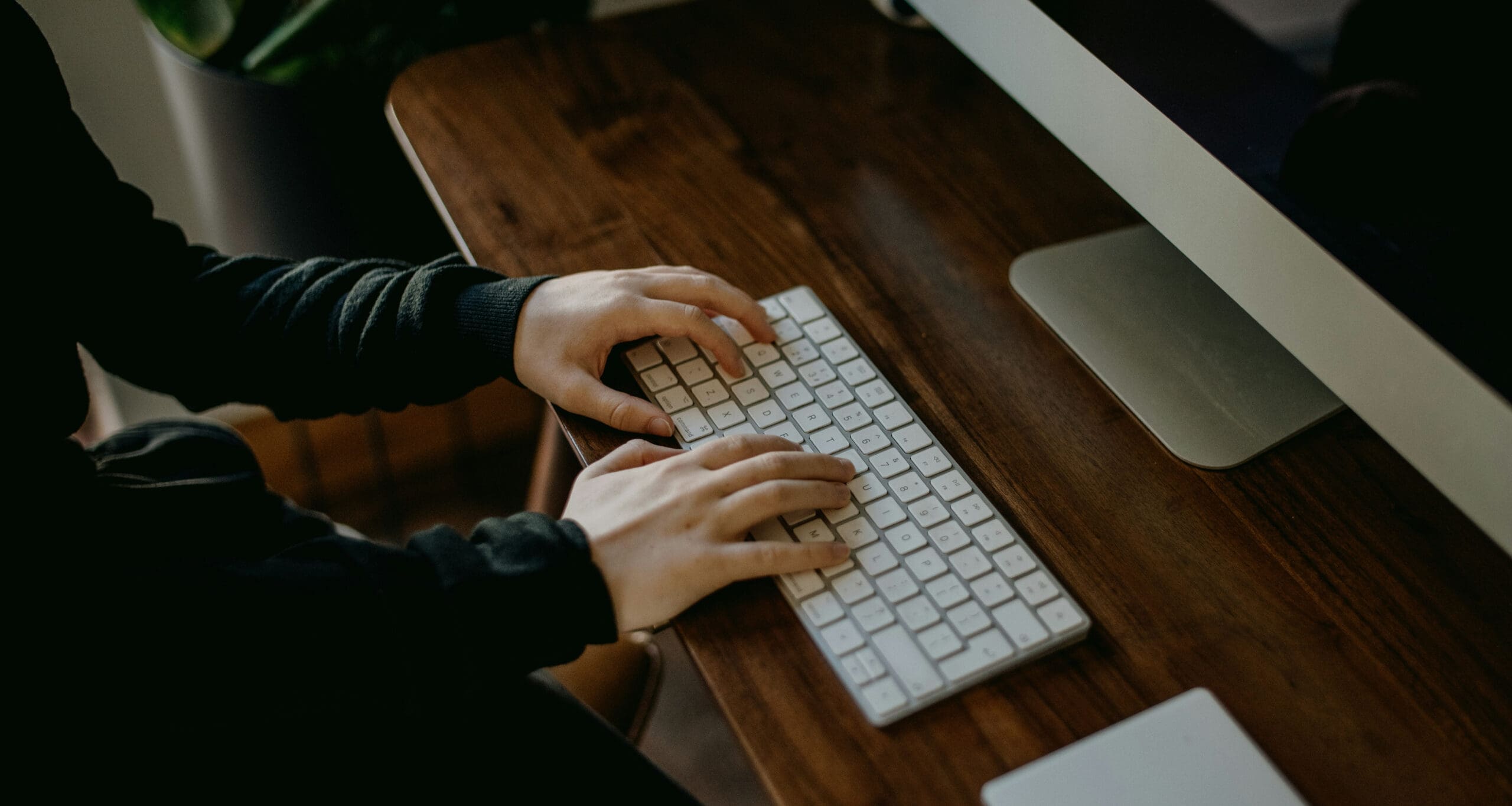 Hands typing on keyboard