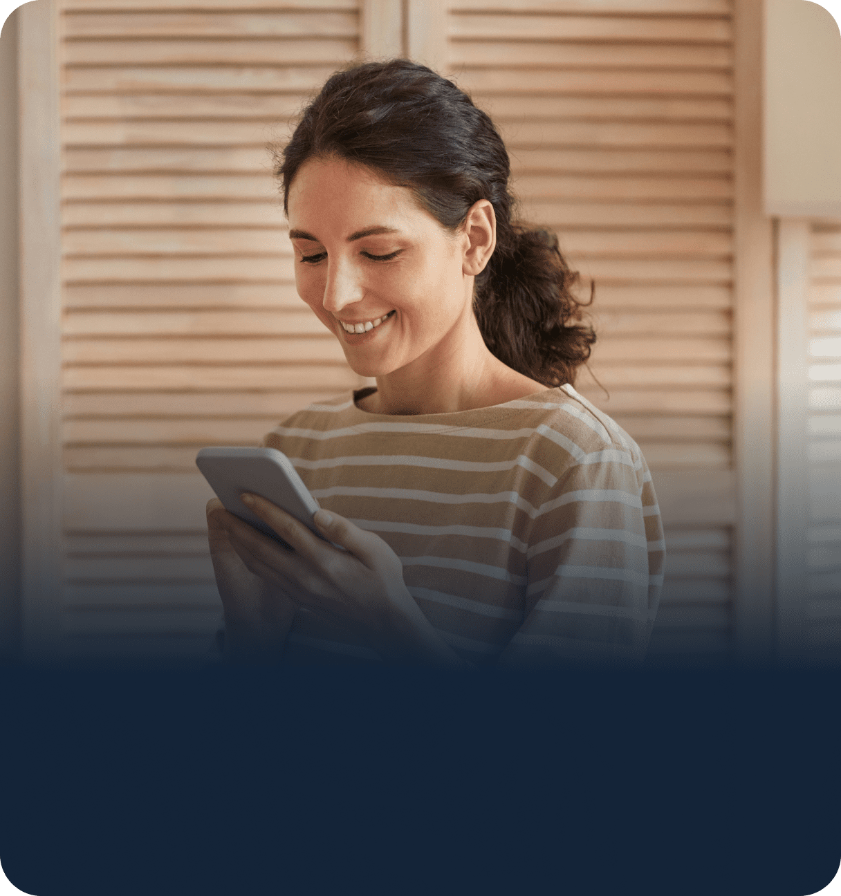 Person smiling looking at phone